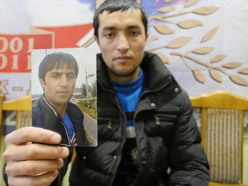 Moscow, Russia - A Tajik labor migrant holds up a picture of his brother, who has been missing for seven days. Image by Iris Oppelaar.