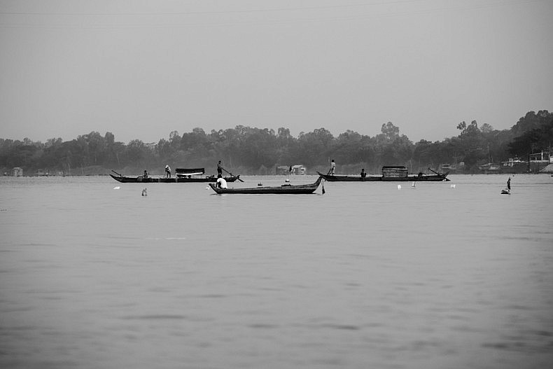 Early morning river traffic near the island of Long Binh. Photo by Gareth Bright.