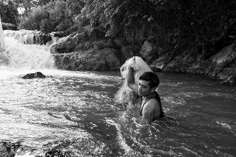 A man wishes in the pools above the Khone Phapheng waterfalls. Photo by Gareth Bright.