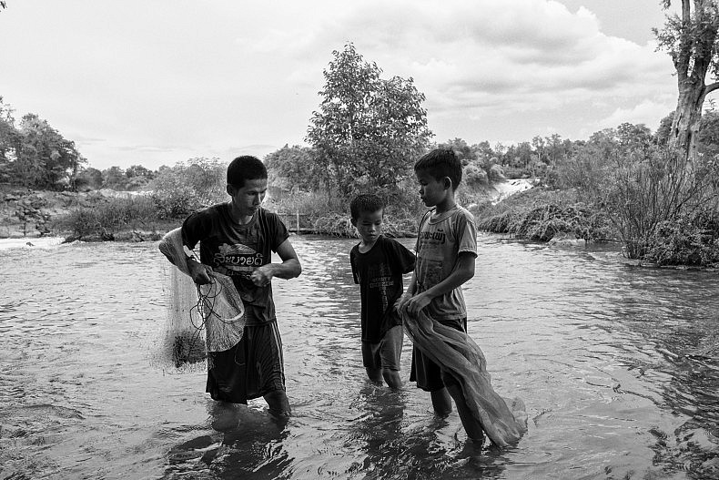 A fisherman and his sons in the Mekong in Laos. Photo by Gareth Bright.