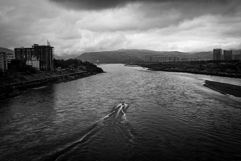 A tourist boat makes its way along the Lancang (Mekong) river in Xishuangbanna, Yunan, China. Photo by Gareth Bright.