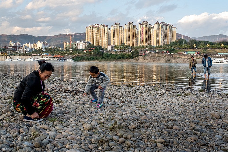 Whether it is called the Lancang or the Mekong, the river brings people to its banks. Photo by Luc Forsyth.